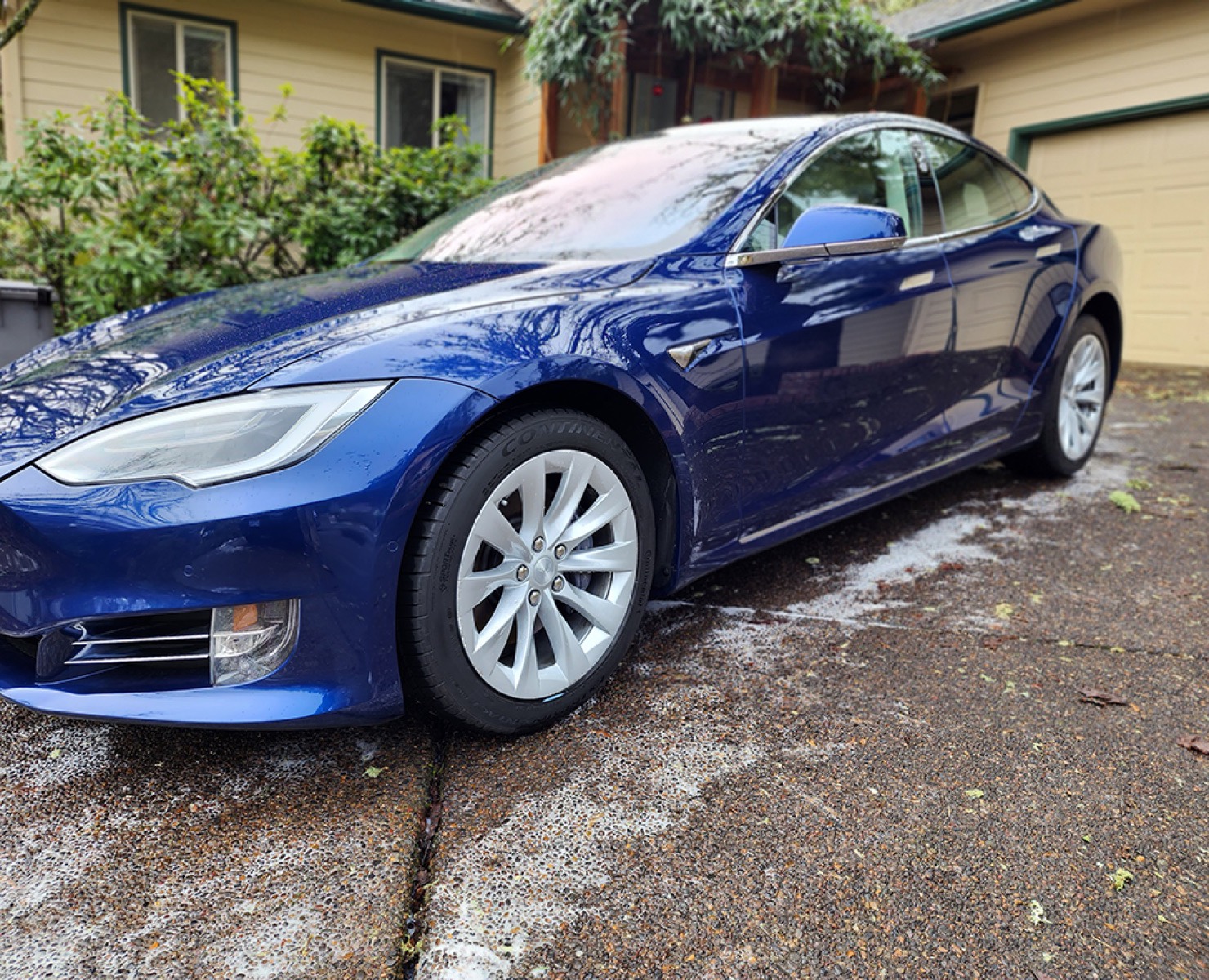 A blue Tesla detailed to a deep gloss by Lux Lab.