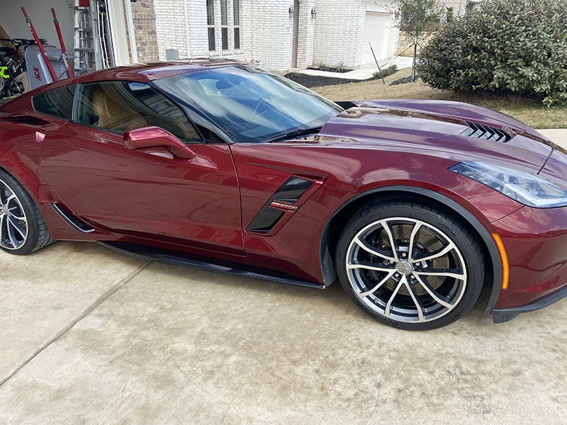 A burgundy Corvette with a flawless, glossy finish.