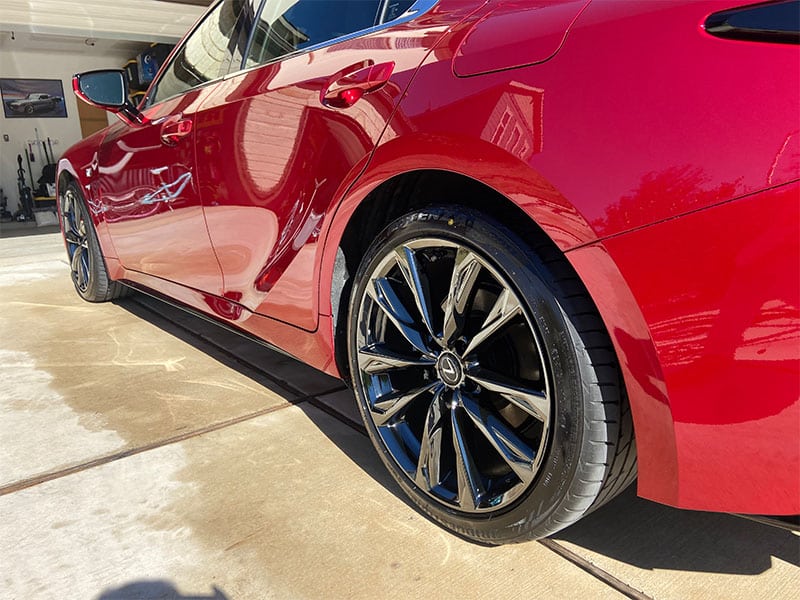 A red Lexus with deep-gloss paint and dressed tires.